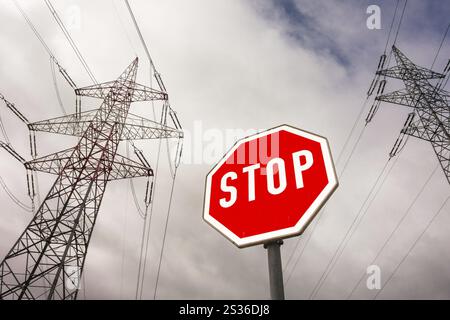 A pylon of a power line and a stop sign. Symbolic photo for phasing out nuclear energy Austria Stock Photo