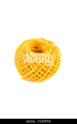 A roll of yellow jute twine placed on a white background, ideal for crafting, packaging, and DIY projects. Perfect for online stores or product catalo Stock Photo