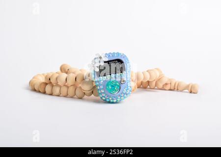 Tasbih. Digital prayer beads hand tally counter and Wooden prayer beads isolated on white background. Used by Muslims in worship especially in the hol Stock Photo