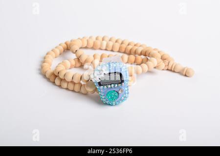 Tasbih. Digital prayer beads hand tally counter and Wooden prayer beads isolated on white background. Used by Muslims in worship especially in the hol Stock Photo