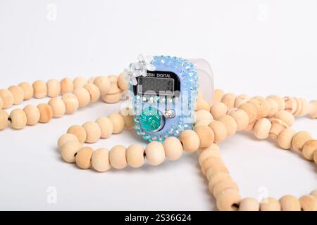 Tasbih. Digital prayer beads hand tally counter and Wooden prayer beads isolated on white background. Used by Muslims in worship especially in the hol Stock Photo