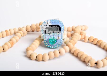 Tasbih. Digital prayer beads hand tally counter and Wooden prayer beads isolated on white background. Used by Muslims in worship especially in the hol Stock Photo