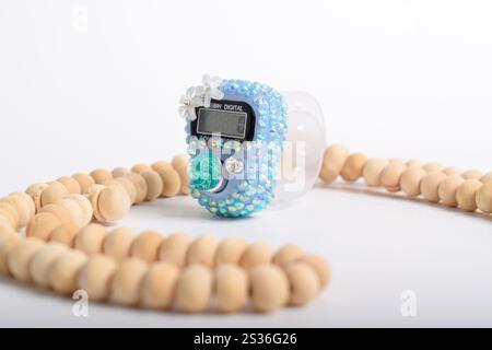 Tasbih. Digital prayer beads hand tally counter and Wooden prayer beads isolated on white background. Used by Muslims in worship especially in the hol Stock Photo