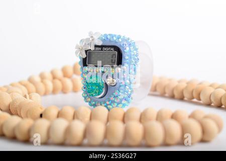 Tasbih. Digital prayer beads hand tally counter and Wooden prayer beads isolated on white background. Used by Muslims in worship especially in the hol Stock Photo