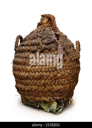 Ceramic wine bottle in wicker basket isolated with clipping path on white background Stock Photo