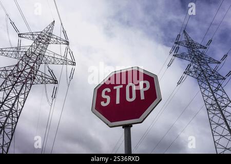 A pylon of a power line and a stop sign. Symbolic photo in favour of phasing out nuclear energy Stock Photo