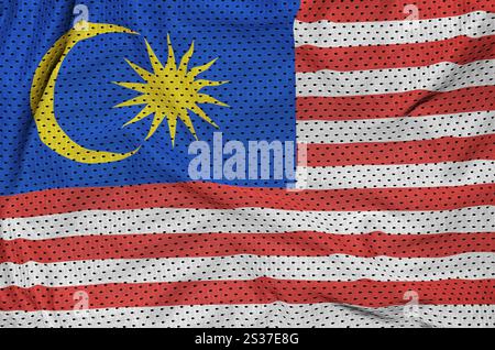 Malaysia flag printed on a polyester nylon sportswear mesh fabric with some folds Stock Photo