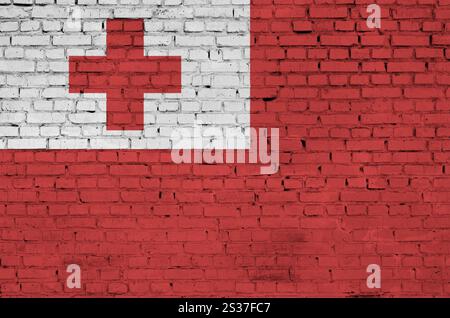 Tonga flag is painted onto an old brick wall Stock Photo