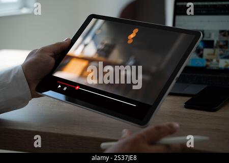 Man watching online videos on Tablet Movie streaming app  at home Stock Photo