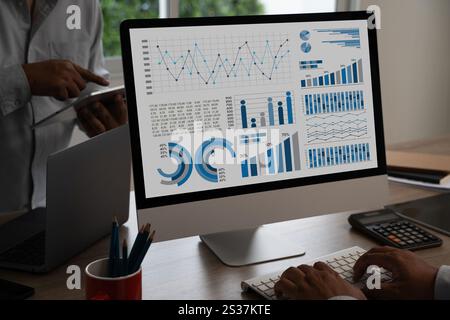 businessman works Statistics Data Dashboard Information Business Technology and Strategy Research analyzing data on computer Stock Photo