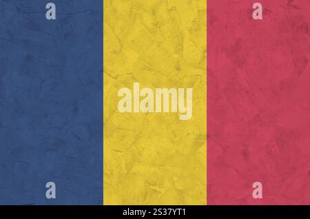 Chad flag depicted in bright paint colors on old relief plastering wall close up. Textured banner on rough background Stock Photo