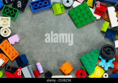 Colorful Plastic Blocks Arranged on Gray Background in Creative Formation Stock Photo