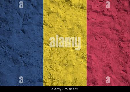 Chad flag depicted in bright paint colors on old relief plastering wall close up. Textured banner on rough background Stock Photo