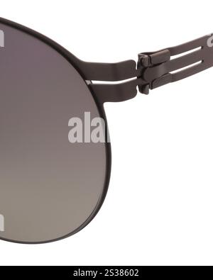 Detail of temple and hinge of round Panto shaped metal sunglasses with violet-green lenses close up Stock Photo