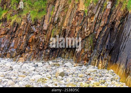 Wet rocks on a beach in low tide Stock Photo