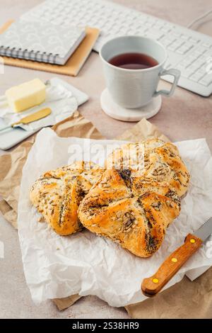 Lunch in a office, delicious bread rolls with butter and coffee on desktop Stock Photo