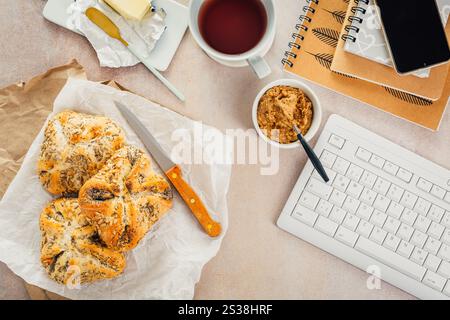 Lunch in a office, delicious bread rolls with butter and coffee on desktop Stock Photo