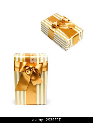 Gift boxes in gold duo tone with golden satin ribbons. Gift boxes Stock Photo