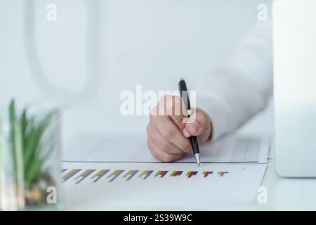 Businesswoman Accountant analyzing investment charts Invoice and pressing calculator buttons over documents. Accounting Bookkeeper Clerk Bank Advisor Stock Photo