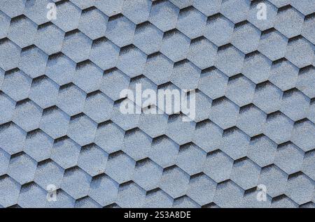 Modern roofing and decoration of chimneys. Flexible bitumen or slate shingles in hexagon shape. Top view texture. Modern roofing and decoration of Stock Photo