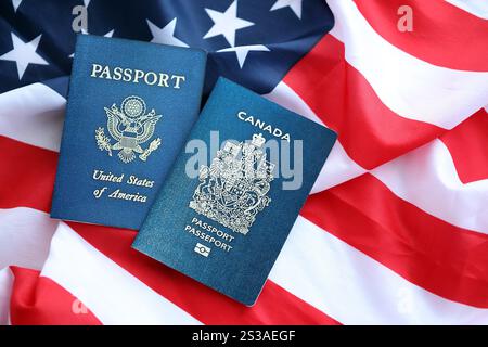 Passport of Canada with US Passport on United States of America folded flag close up Stock Photo