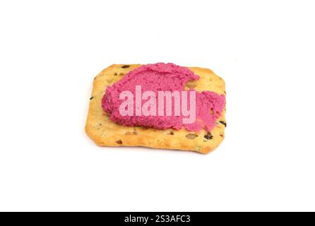 Beetroot hummus spread on a cracker isolated on white background Stock Photo