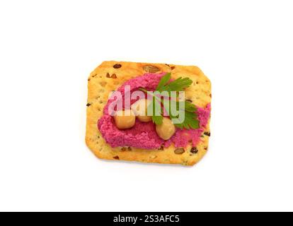 Beetroot hummus spread on a cracker isolated on white background Stock Photo