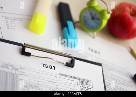 Blank educational test for students lies on table in classroom with pen ...