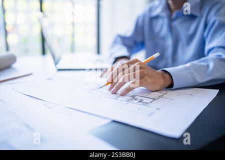 Architecture Man drawing on architectural Creative project business architecture building construction Industrial engineering Achievement Planning. Stock Photo