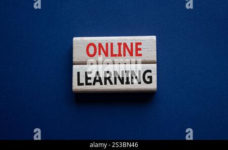 Online learning symbol. Wooden blocks with words Online learning. Beautiful deep blue background. Business and Online learning concept. Copy space. Stock Photo
