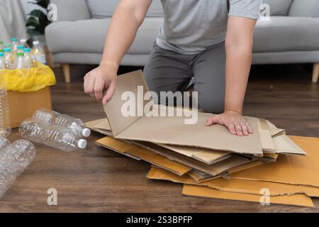 Home recycle eco zero waste concept Man using recycle paper box. Stacking brown cardboard box eco friendly packaging made of recyclable raw materials Stock Photo