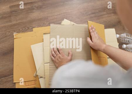 Home recycle eco zero waste concept Man using recycle paper box. Stacking brown cardboard box eco friendly packaging made of recyclable raw materials Stock Photo