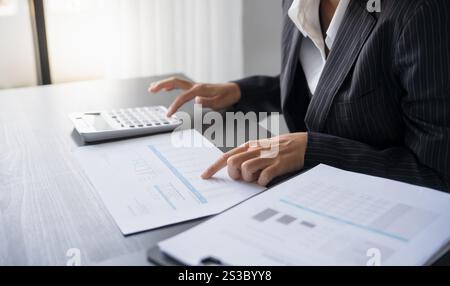business man Auditor or internal revenue service staff checking annual financial statements company Audit Accounting tax. Stock Photo