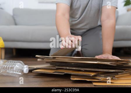 Home recycle eco zero waste concept Man using recycle paper box. Stacking brown cardboard box eco friendly packaging made of recyclable raw materials Stock Photo