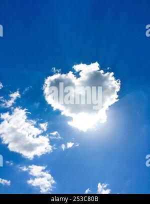 Heart shaped cloud in blue sky Stock Photo - Alamy
