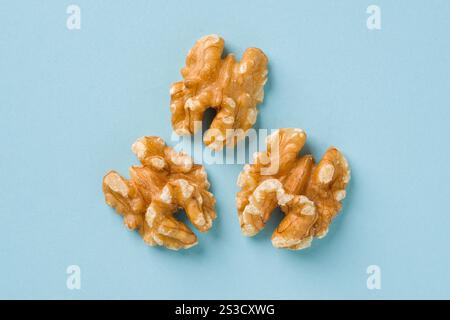 Top view of half walnut kernel on blue background Stock Photo