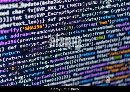 A close-up image of a computer monitor displaying unidentified code in a dark background, enhancing readability a Stock Photo