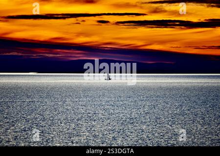 fisher boat in a colorful sundown/sunset in the arcic sea Stock Photo