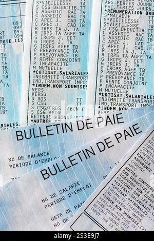 Several French payrolls, with some of the many lines of social security contributions and taxes paid by employees and employers in France Stock Photo