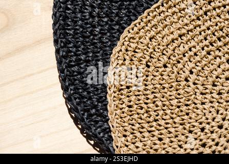 Raffia napkins, black and beige, close-up. Crochet. Eco material for handmade work. Stock Photo