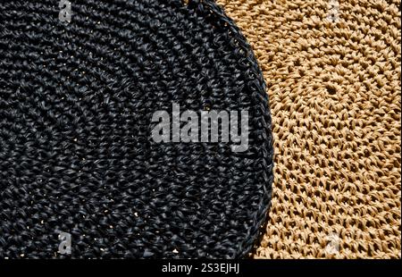 Raffia napkins, black and beige, close-up. Crochet. Eco material for handmade work. Stock Photo