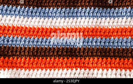 Crochet, pattern from multi-colored cotton threads, double crochet. Handmade concept, hobby, background, fashionable online knitting course. Stock Photo