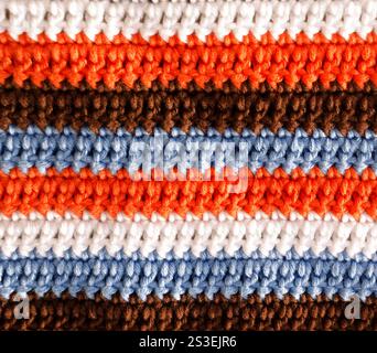 Crochet, pattern from multi-colored cotton threads, double crochet. Handmade concept, hobby, background, fashionable online knitting course. Stock Photo