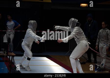 Two fencing champions clash in an intense tournament match, showcasing their skill and precision in this thrilling sport Stock Photo