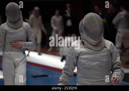 Two fencing champions clash in an intense tournament match, showcasing their skill and precision in this thrilling sport Stock Photo