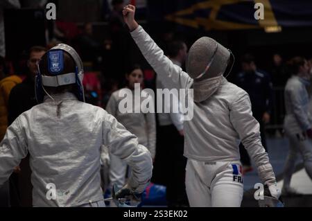 Two fencing champions clash in an intense tournament match, showcasing their skill and precision in this thrilling sport Stock Photo