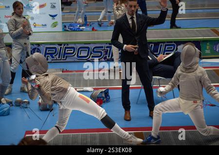 Two fencing champions clash in an intense tournament match, showcasing their skill and precision in this thrilling sport Stock Photo