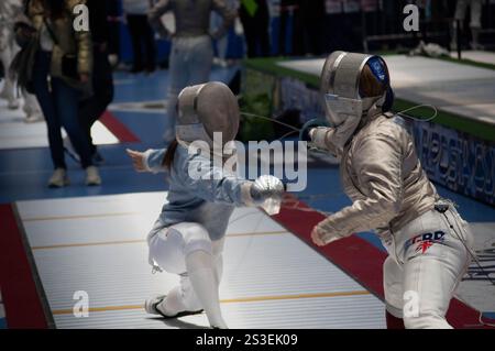 Two fencing champions clash in an intense tournament match, showcasing their skill and precision in this thrilling sport Stock Photo