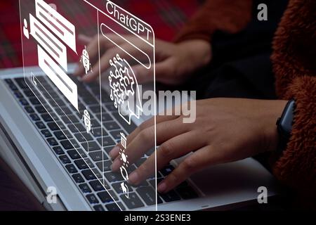 ChatGPT Chat with AI or Artificial Intelligence. Young Entrepreneur chatting with a smart AI or artificial intelligence using an artificial intelligen Stock Photo