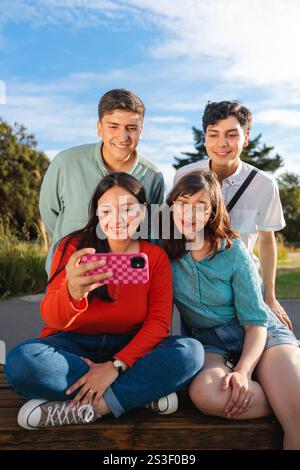 Group of young students taking a selfie in the park Stock Photo